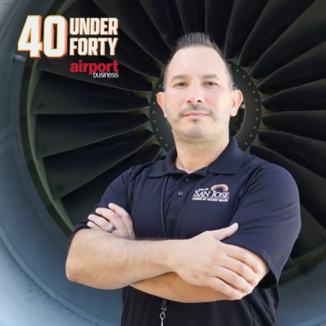 Headshot of Chris Fernandez in front of an airplane engine.